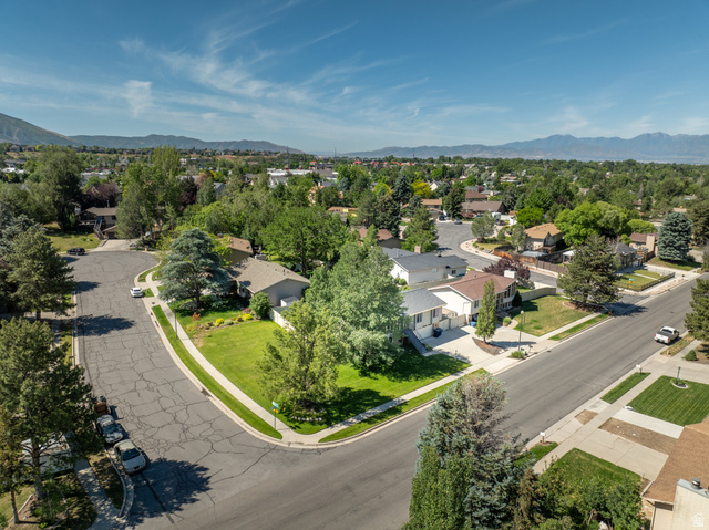 2088 Falcon Way Sandy, UT 84093 - Photo 38 of 46 Suburban neighborhood with mature trees, green lawns, and paved streets