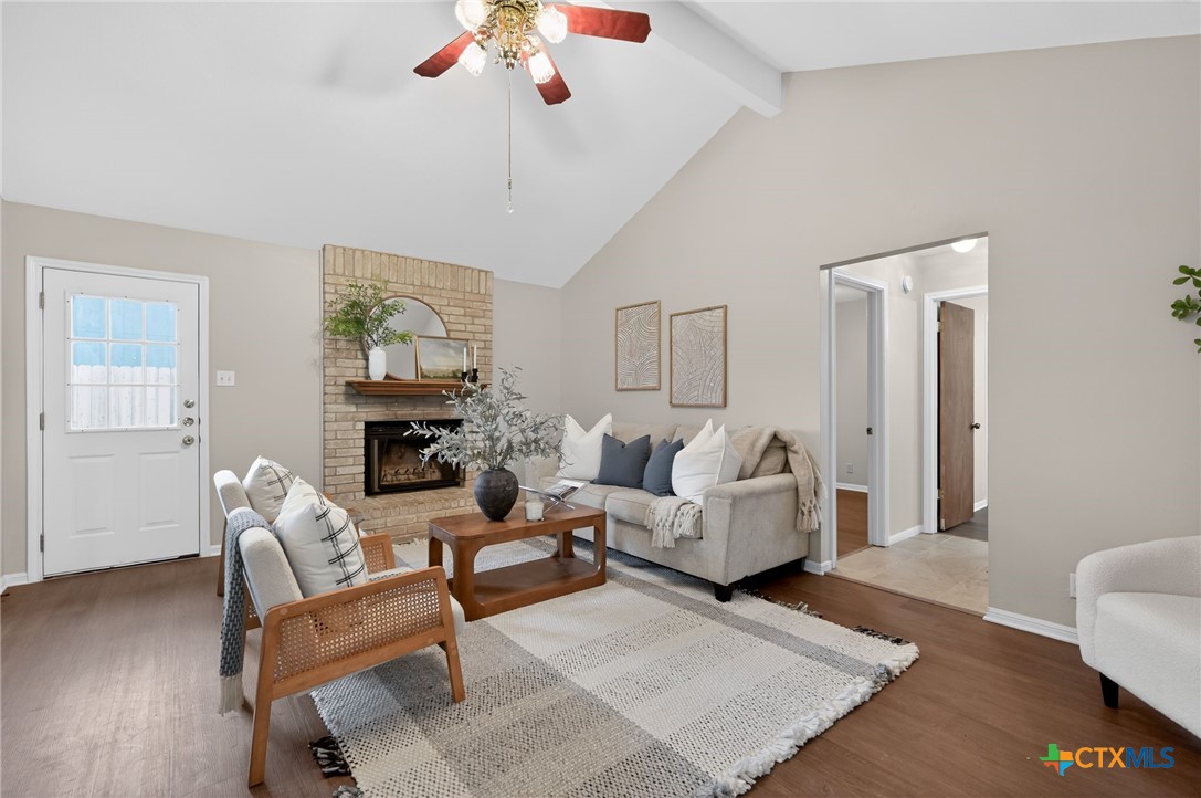 1719 Ridgeway Drive Temple, TX 76502 - Photo 5 of 28 Cozy fireplace, ceiling fan, beamed ceiling, and new LVP flooring.