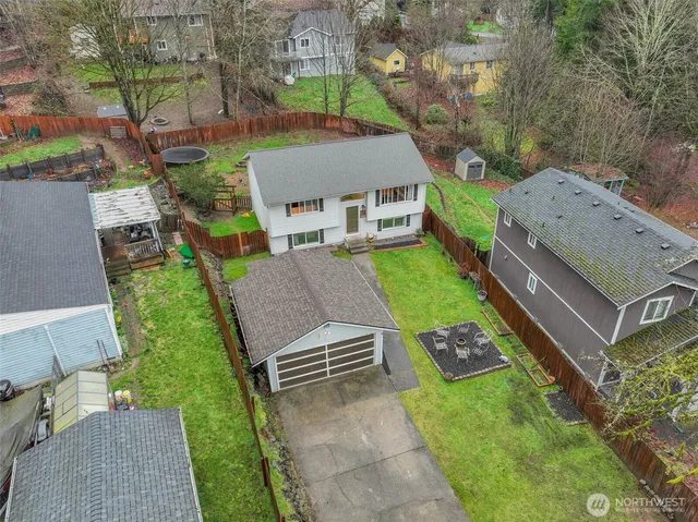 an aerial view of a house with a yard