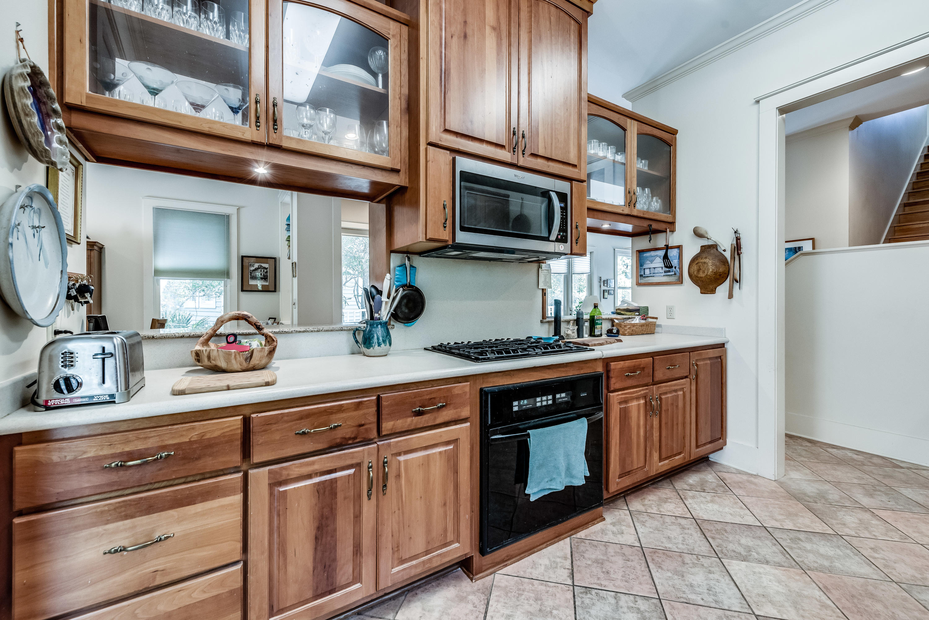 Tidy galley kitchen with tile floor