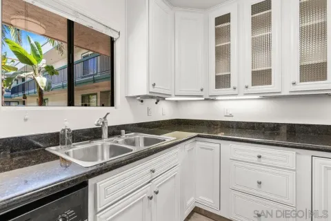 a kitchen with granite countertop a sink and a window