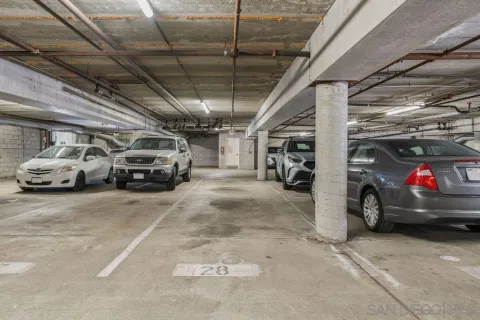 a view of parking garage with cars parked