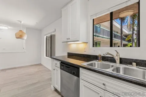 a kitchen with granite countertop a sink and a stove