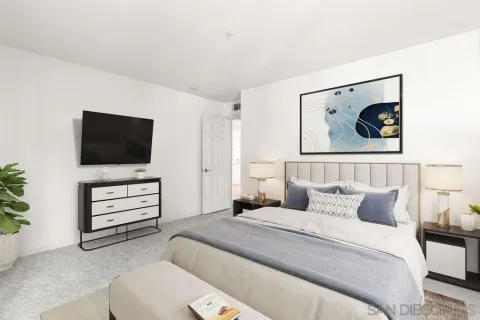 a bedroom with a bed and a flat screen tv