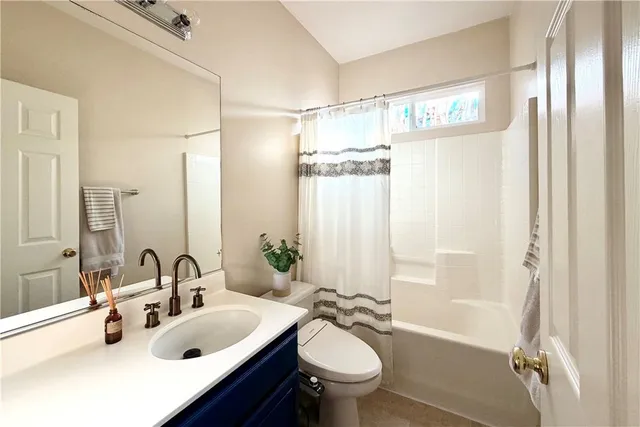 a bathroom with a sink toilet tub and shower