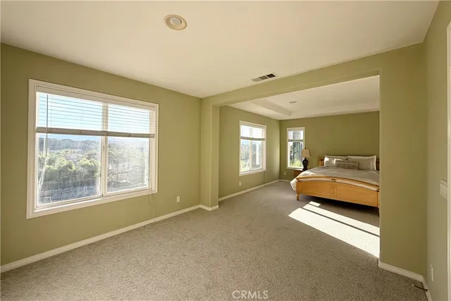 a bedroom with bed and window