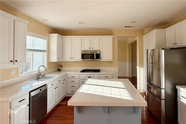 a kitchen with a sink stove and refrigerator
