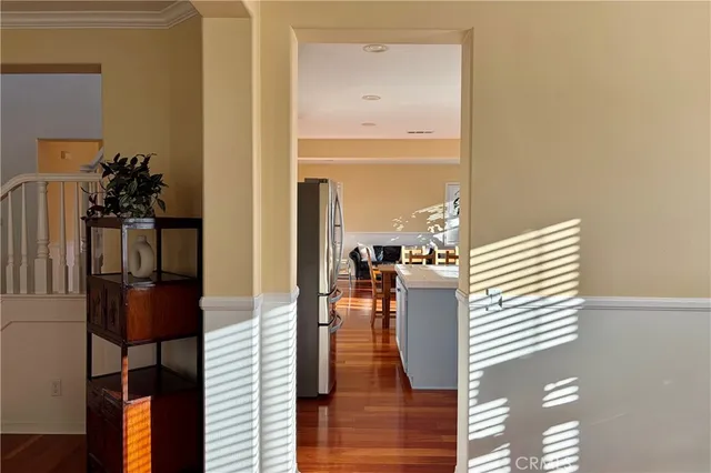 a hallway with a view of living room with furniture