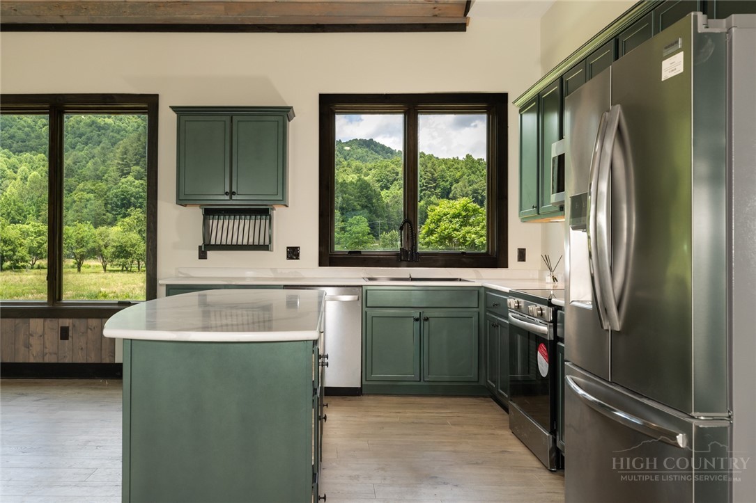 790 Howard Edmisten Road Sugar Grove, NC 28679 - Photo 10 of 45 a kitchen with a sink cabinets and a large window