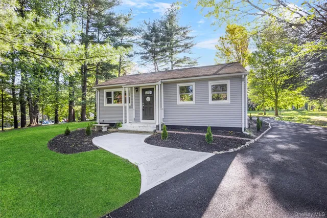 a view of a house with a yard and tree s