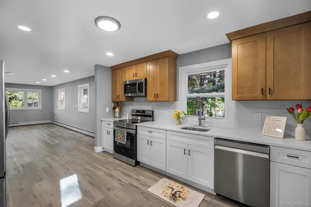 a kitchen with a sink cabinets and window