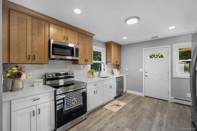 a kitchen with a sink stove top oven and cabinets