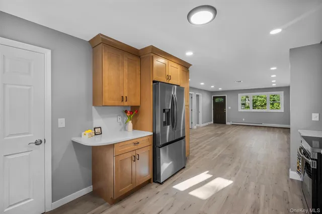 a kitchen with stainless steel appliances granite countertop a refrigerator and a sink