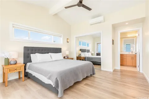 a bedroom with a bed and a mirror