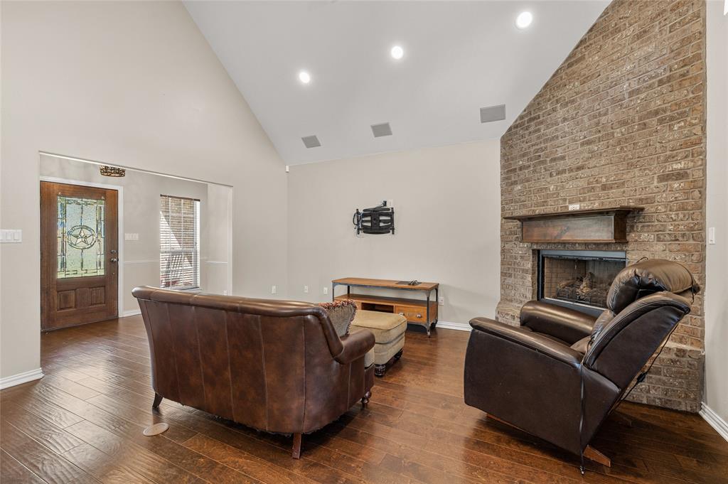 10264 Farmington Road Van Alstyne, TX 75495 - Photo 11 of 39 a living room with furniture and a fireplace