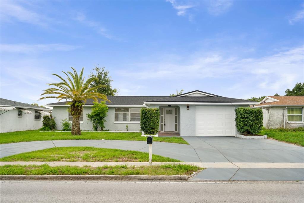 5626 Moog Road Holiday, FL 34690 - Photo 2 of 38 a front view of a house with a yard