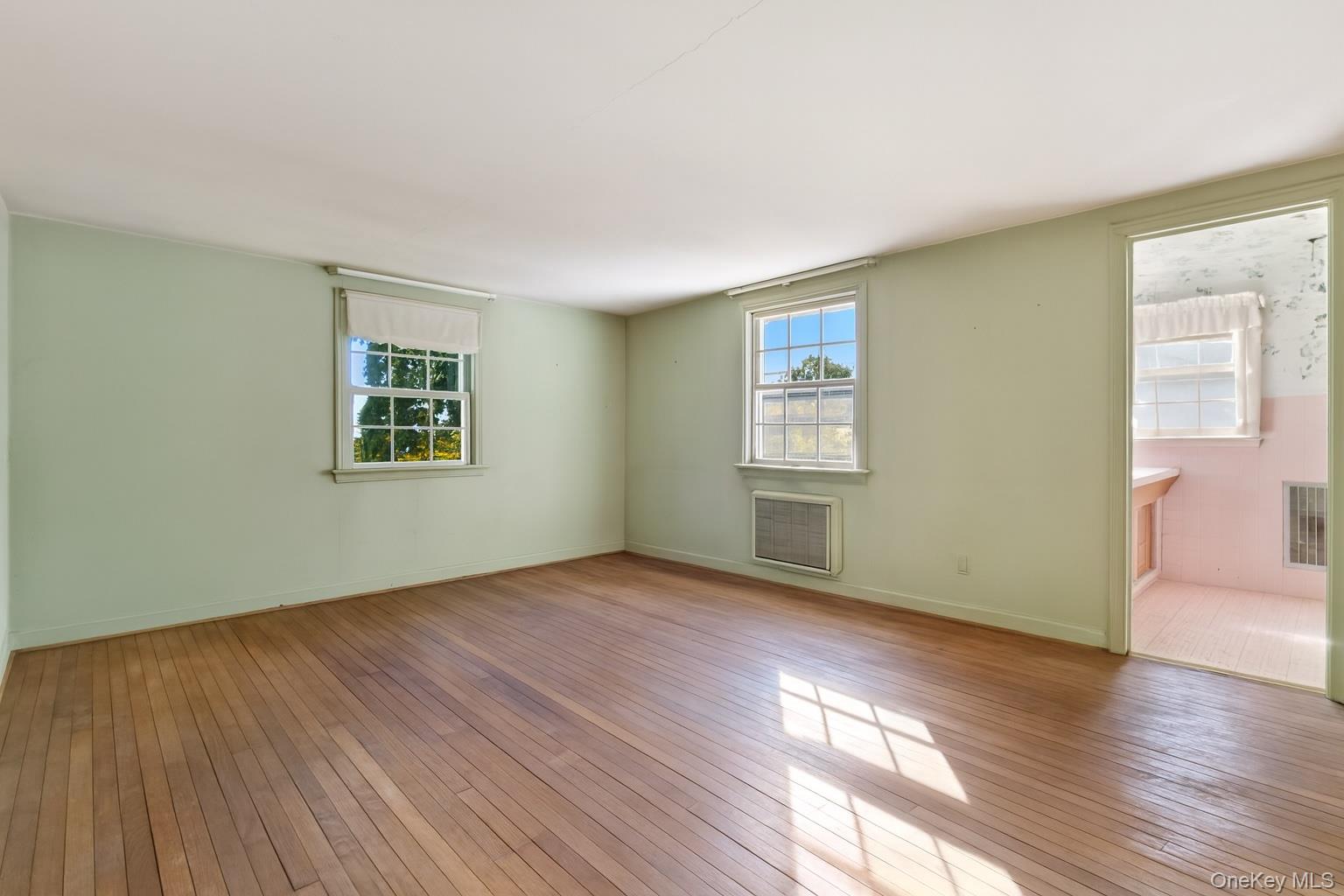 87 Rockledge Road Bronxville, NY 10708 - Photo 7 of 14 an empty room with wooden floor and windows