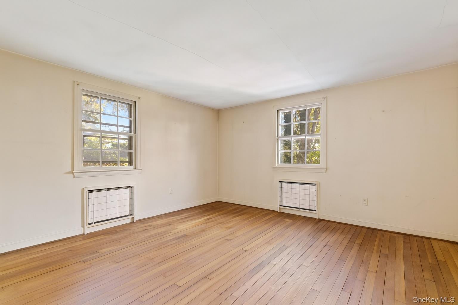 87 Rockledge Road Bronxville, NY 10708 - Photo 8 of 14 an empty room with wooden floor and windows
