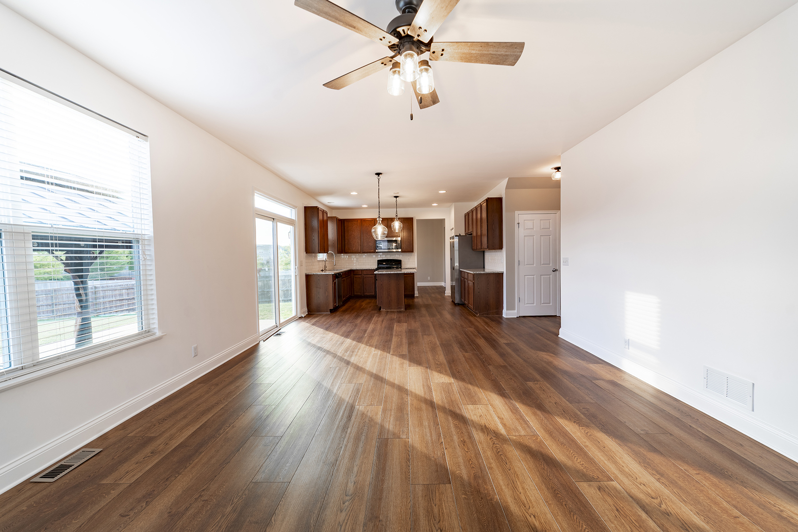 442 Windett Ridge Road Yorkville, IL 60560 - Photo 11 of 26 a view of a living room with kitchen furniture and a ceiling fan