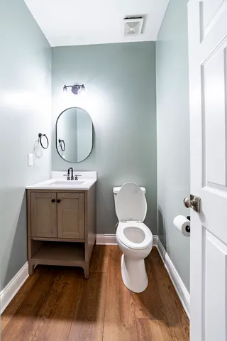 a bathroom with a toilet sink and mirror