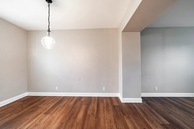 a view of a room with wooden floor and windows