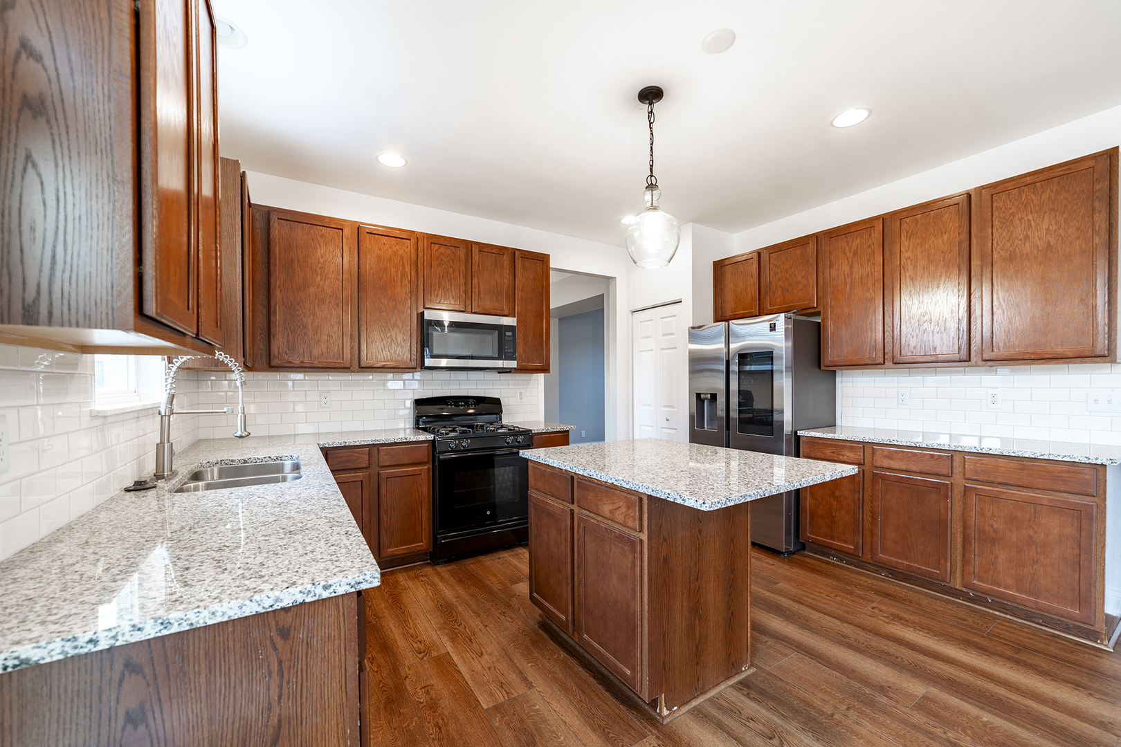 442 Windett Ridge Road Yorkville, IL 60560 - Photo 9 of 26 a kitchen with stainless steel appliances granite countertop a sink stove and refrigerator