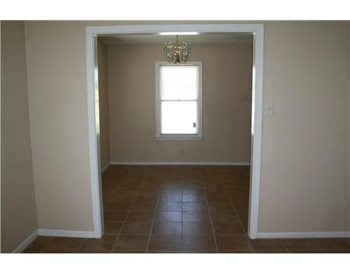 a room with a window and a wooden floor