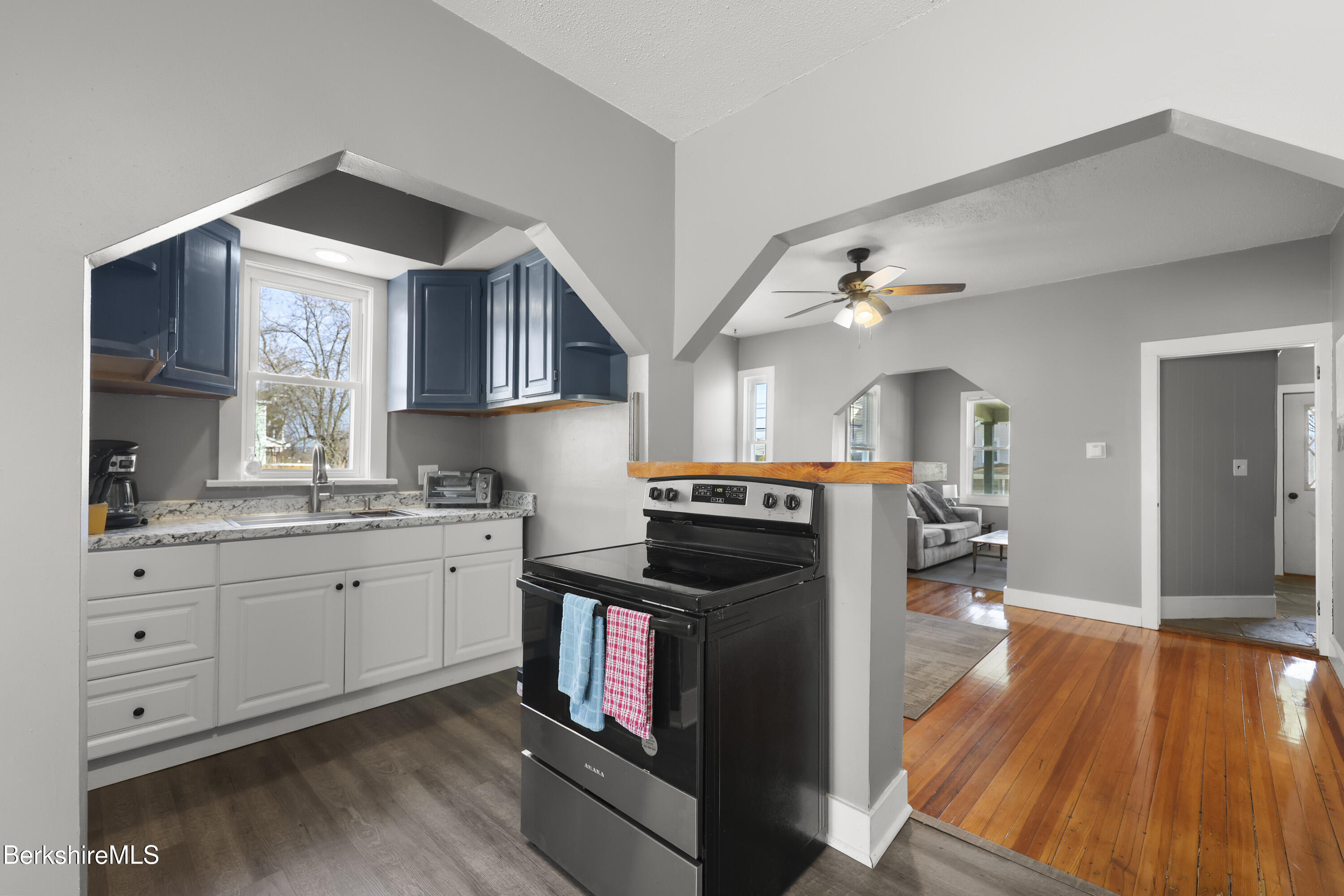 105-107 Onota Street Pittsfield, MA 01201 - Photo 15 of 46 a kitchen with granite countertop a stove a sink and a wooden floors