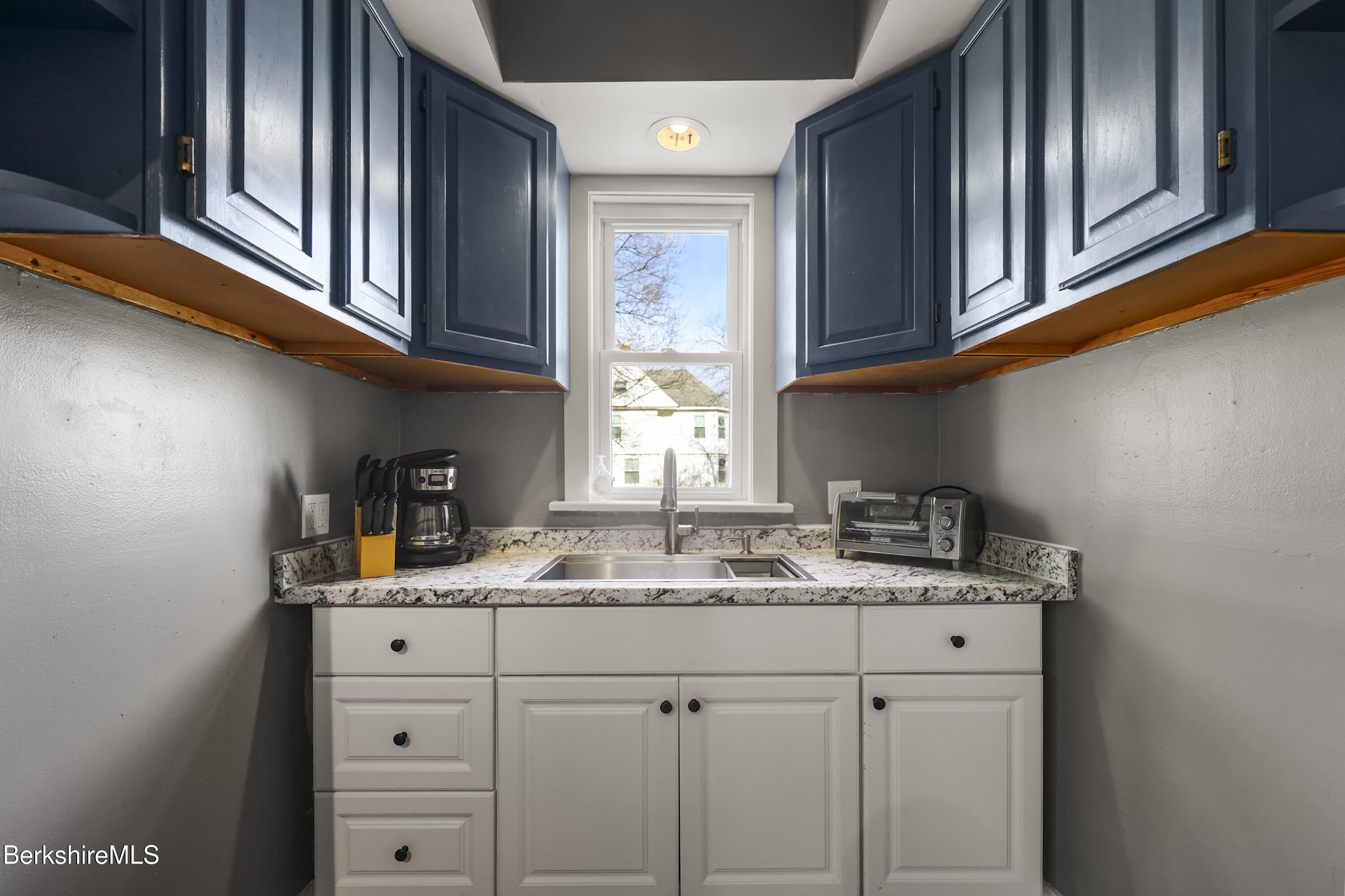105-107 Onota Street Pittsfield, MA 01201 - Photo 16 of 46 a kitchen with stainless steel appliances granite countertop a sink window and cabinets