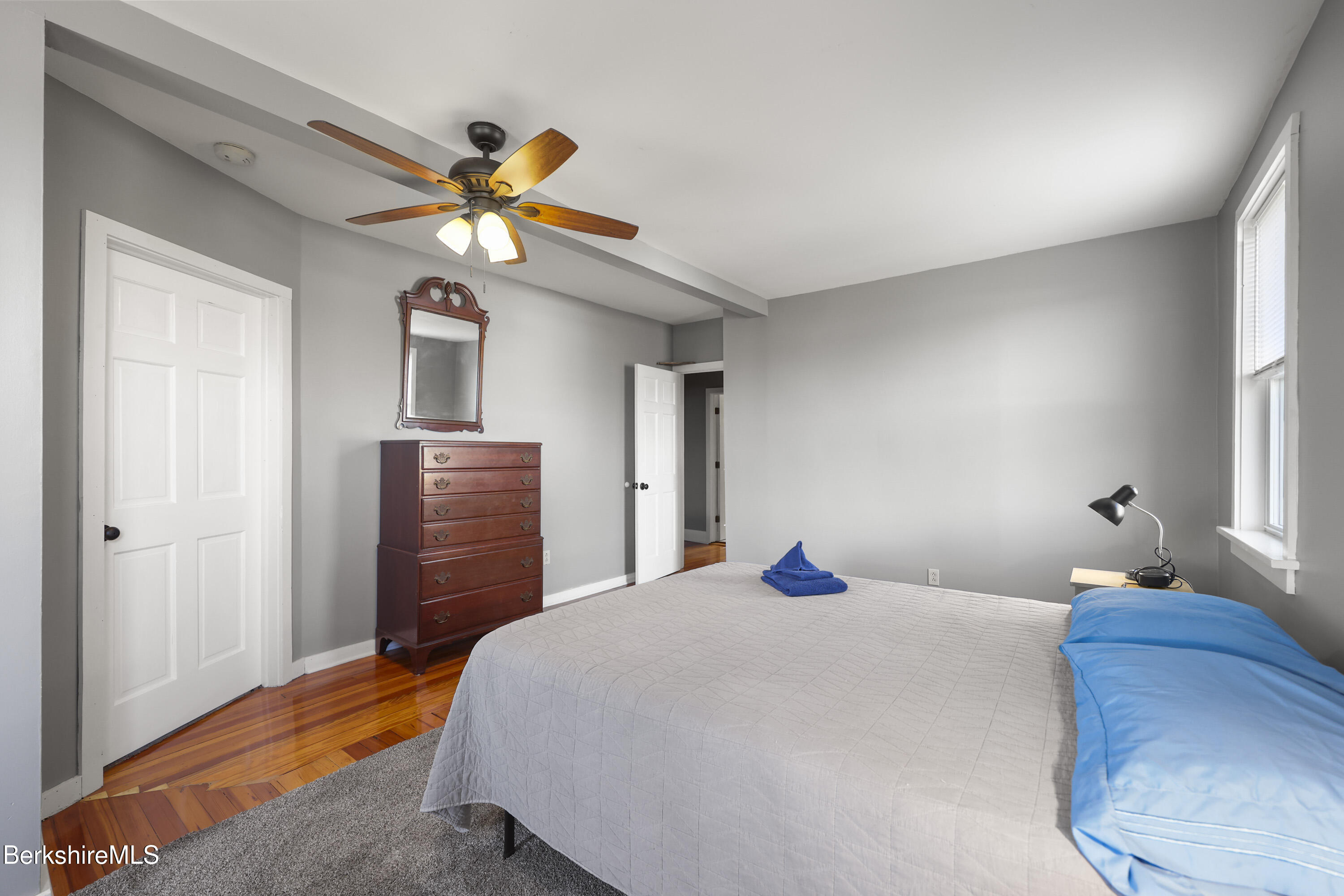 105-107 Onota Street Pittsfield, MA 01201 - Photo 18 of 46 a bedroom with a bed and a chandelier