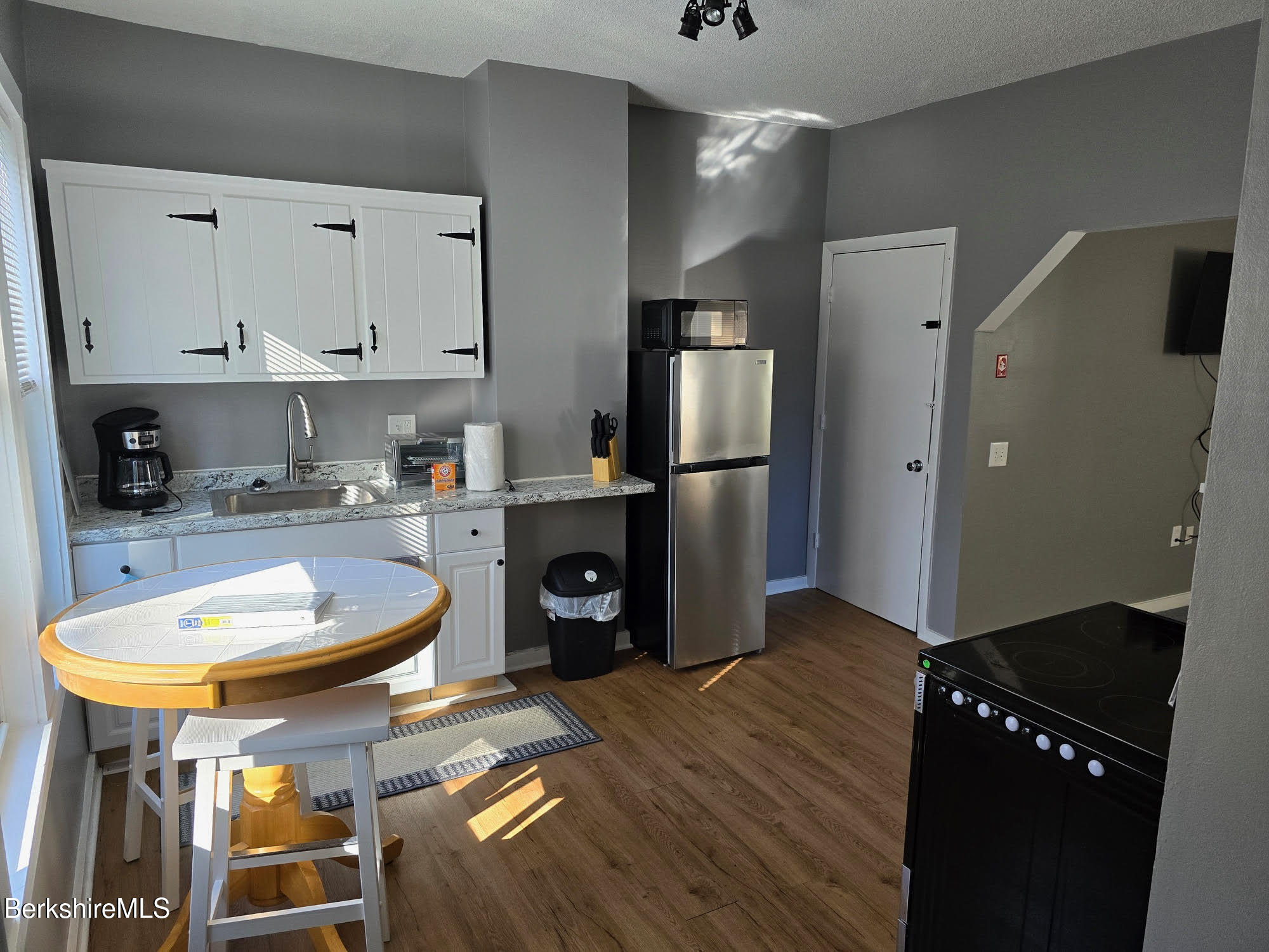 105-107 Onota Street Pittsfield, MA 01201 - Photo 27 of 46 a kitchen with sink refrigerator and cabinets