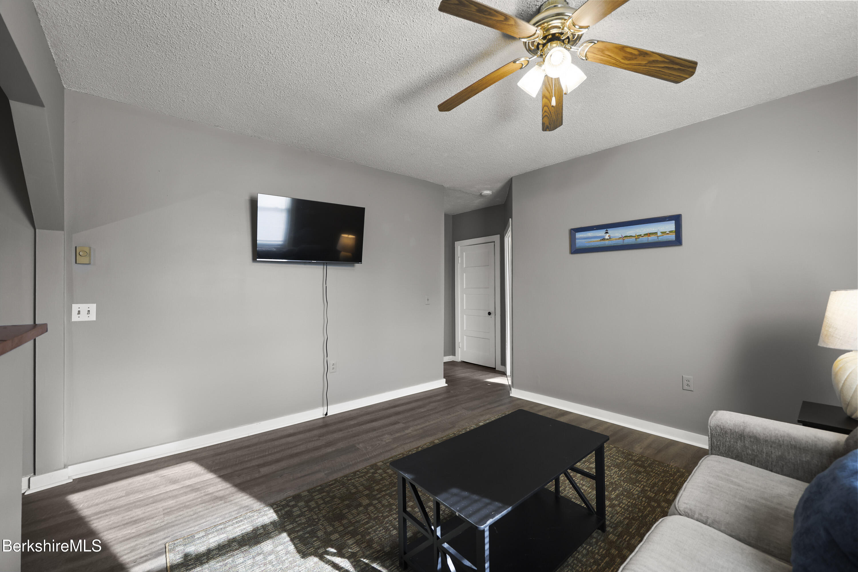105-107 Onota Street Pittsfield, MA 01201 - Photo 29 of 46 a living room with furniture and a flat screen tv