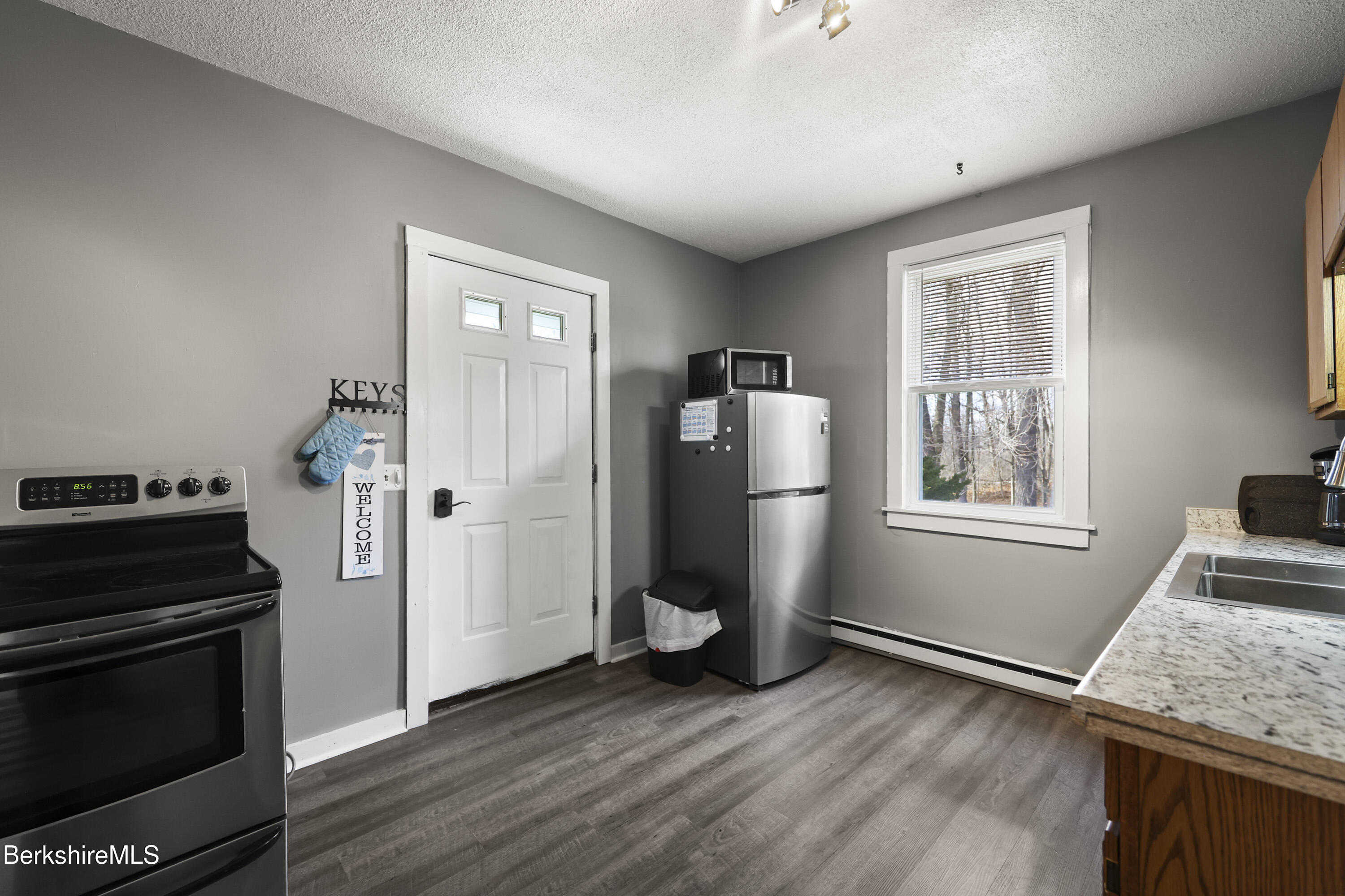 105-107 Onota Street Pittsfield, MA 01201 - Photo 30 of 46 a kitchen with a refrigerator and window