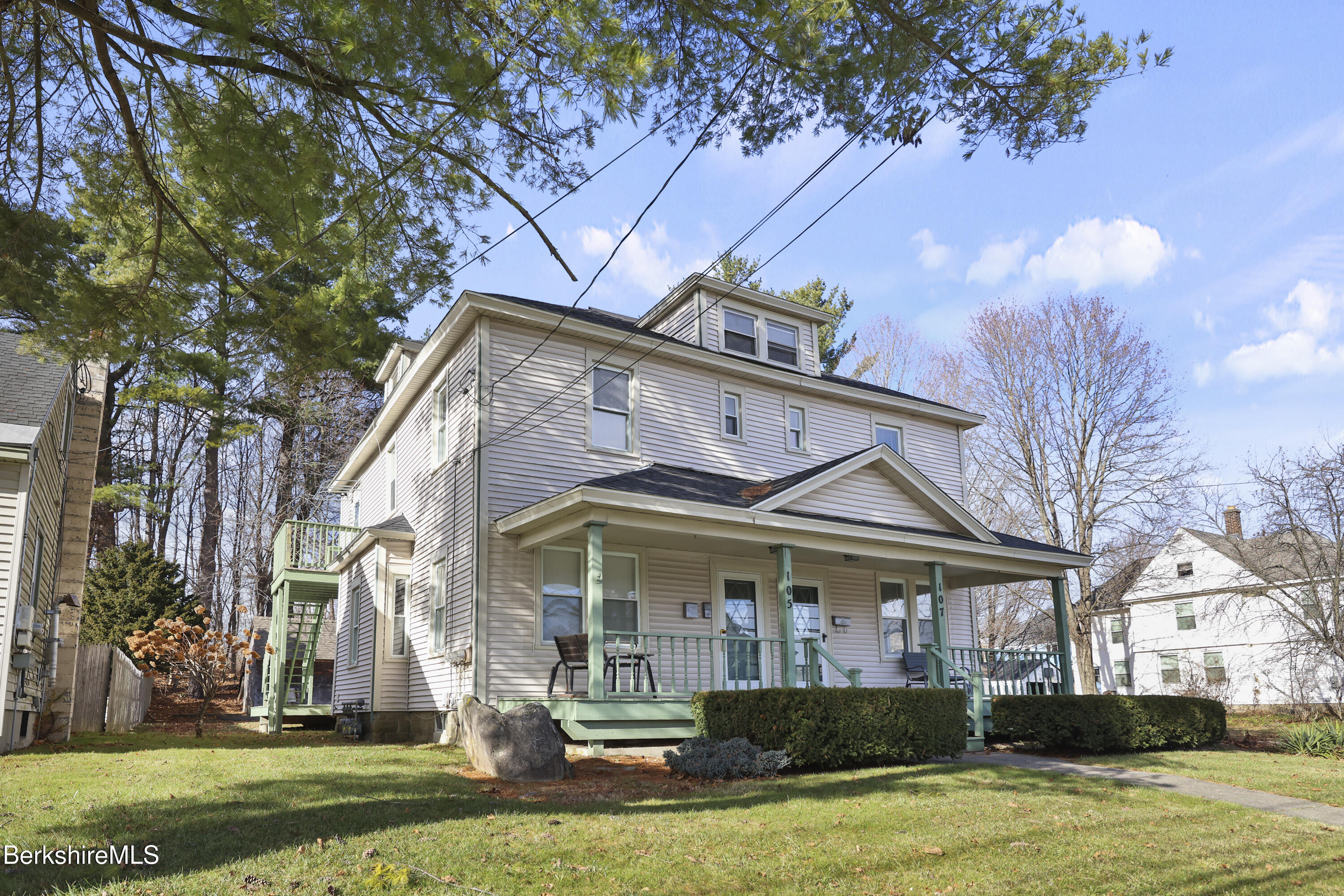 105-107 Onota Street Pittsfield, MA 01201 - Photo 3 of 46 a front view of a house with a yard garage and outdoor seating