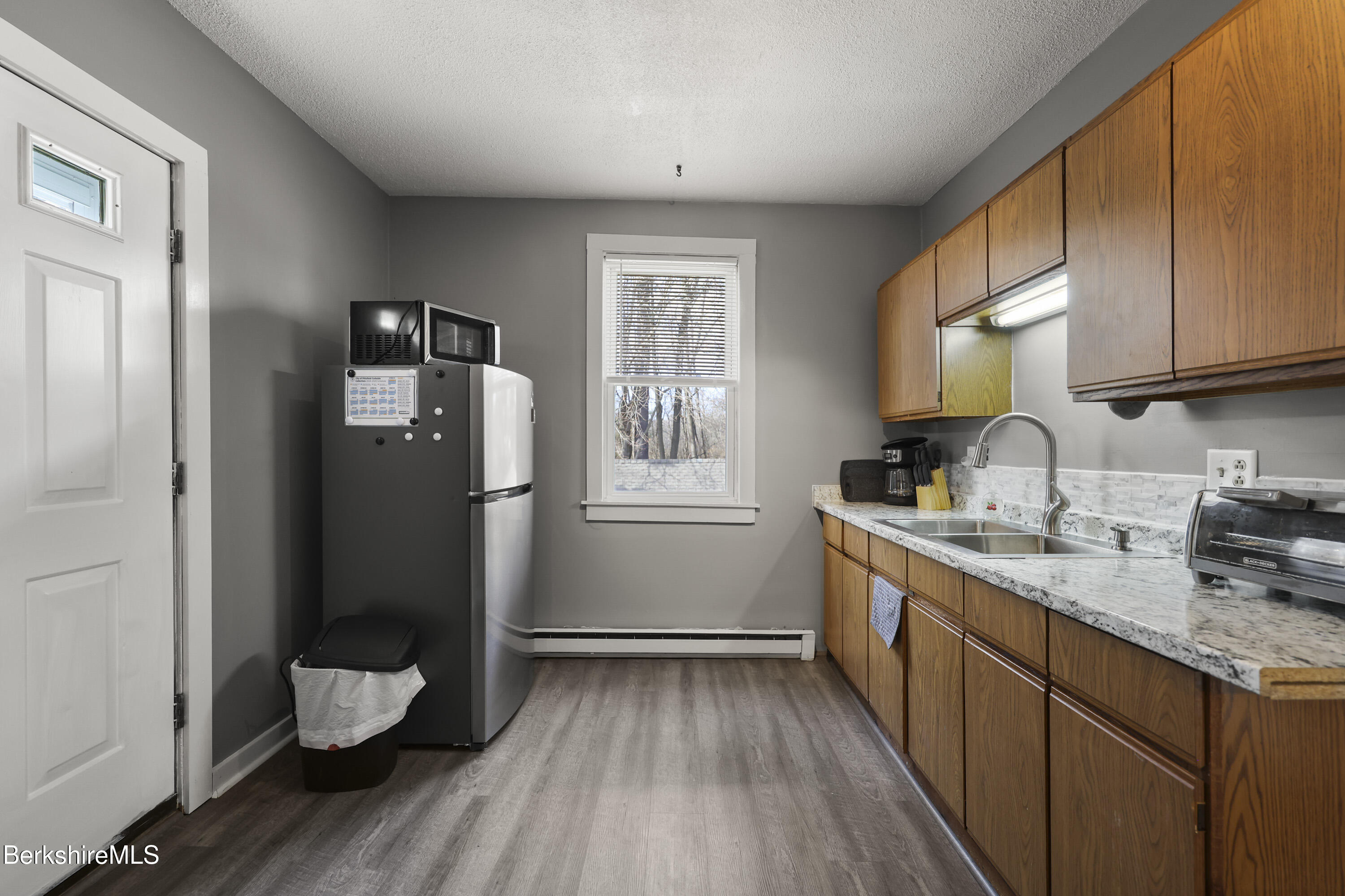 105-107 Onota Street Pittsfield, MA 01201 - Photo 31 of 46 a kitchen with a sink wooden floor and cabinets