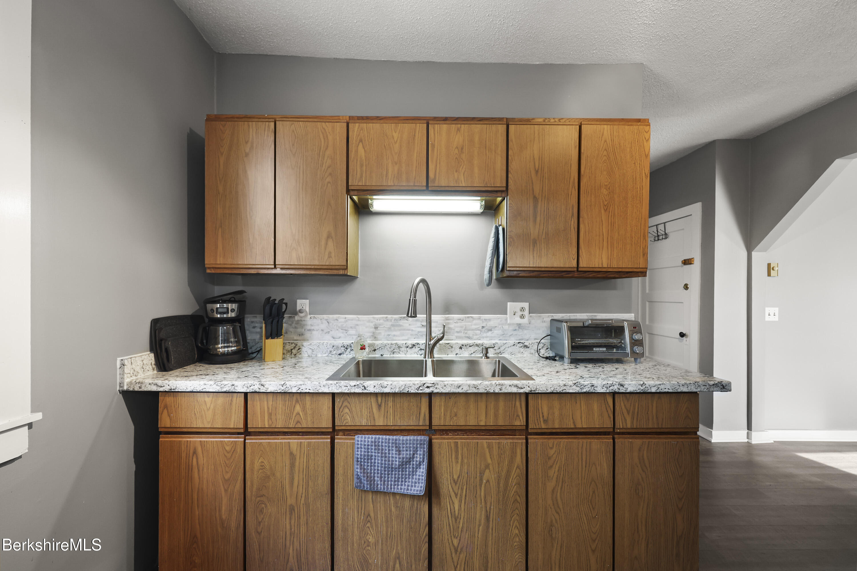 105-107 Onota Street Pittsfield, MA 01201 - Photo 33 of 46 a kitchen with stainless steel appliances granite countertop a sink a refrigerator and cabinets