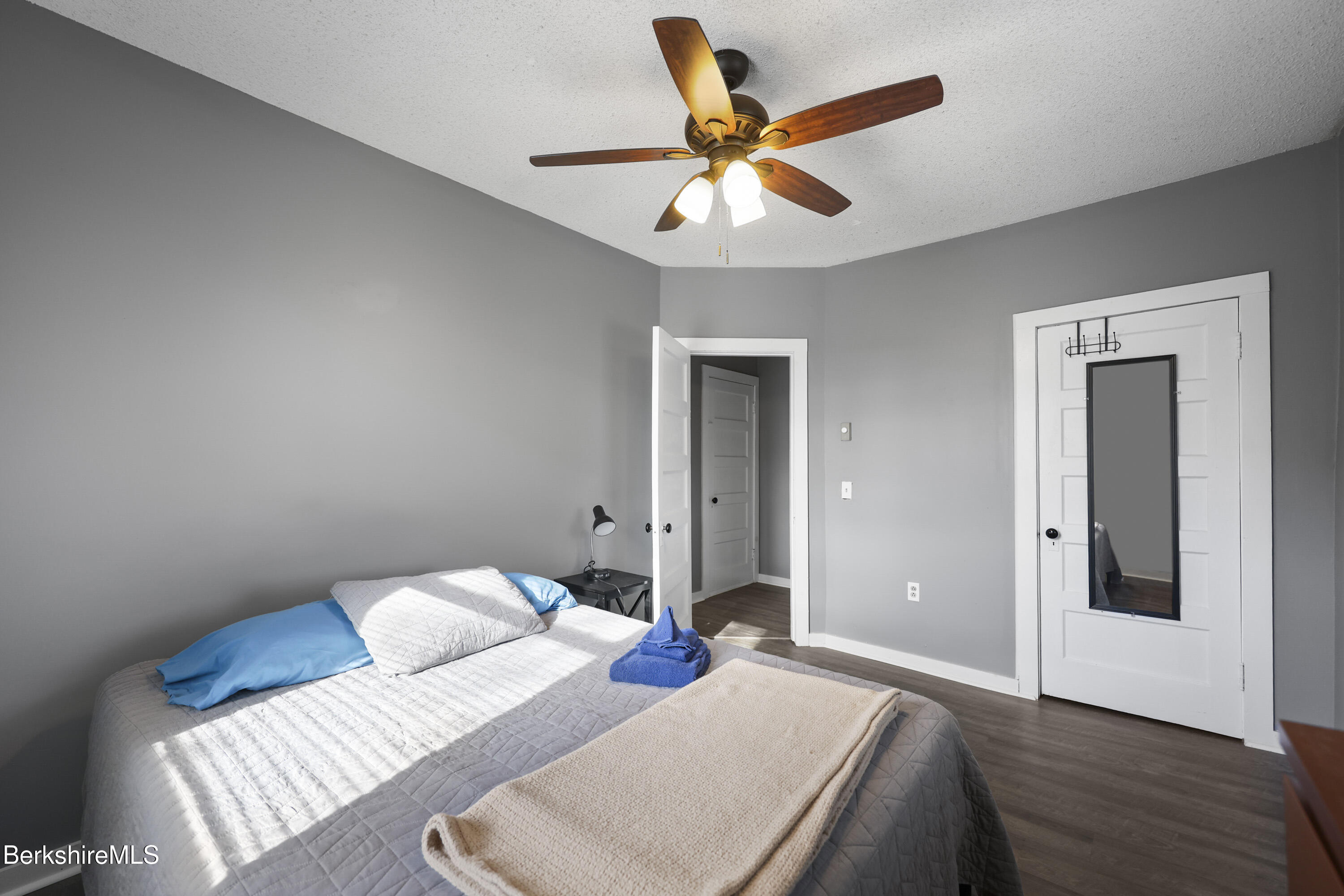 105-107 Onota Street Pittsfield, MA 01201 - Photo 36 of 46 a bedroom with a bed and a chandelier