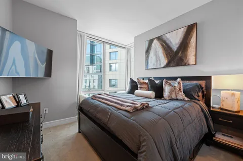 a bed sitting in a bedroom next to a window