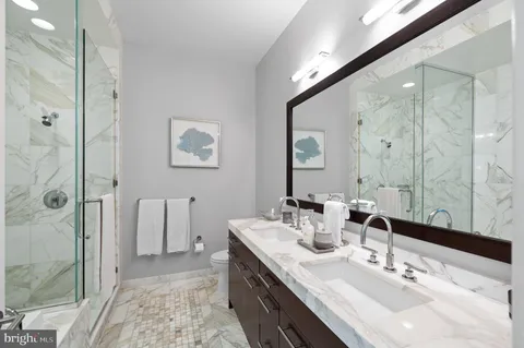 a bathroom with a double vanity sink mirror and double