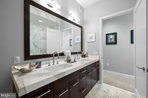 a bathroom with a granite countertop sink two mirror and a