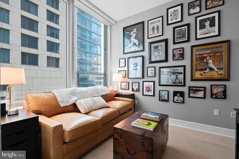 a living room with furniture and painting on the wall