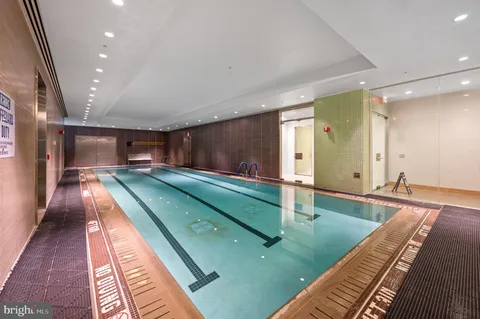 a room with gym equipment and large windows