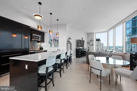 a large kitchen with a table and chairs
