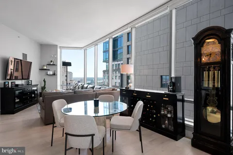 a kitchen with a table chairs and a refrigerator