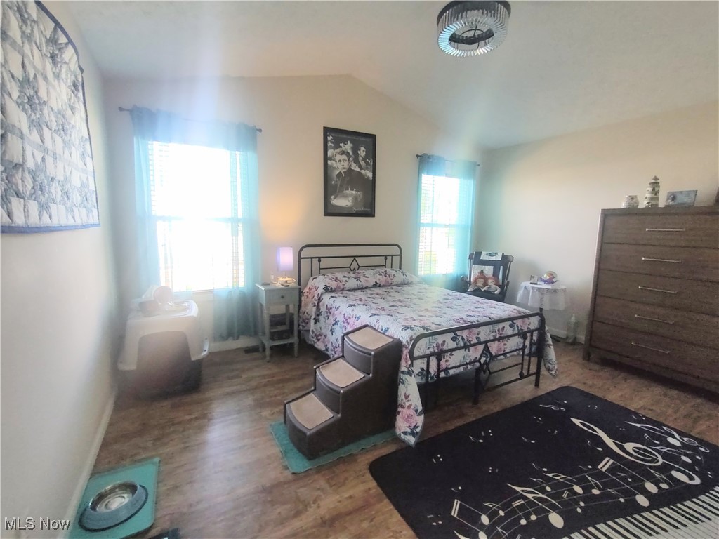 870 Susan Road Ravenna, OH 44266 - Photo 21 of 35 Bedroom featuring vaulted ceiling and dark wood-style flooring
