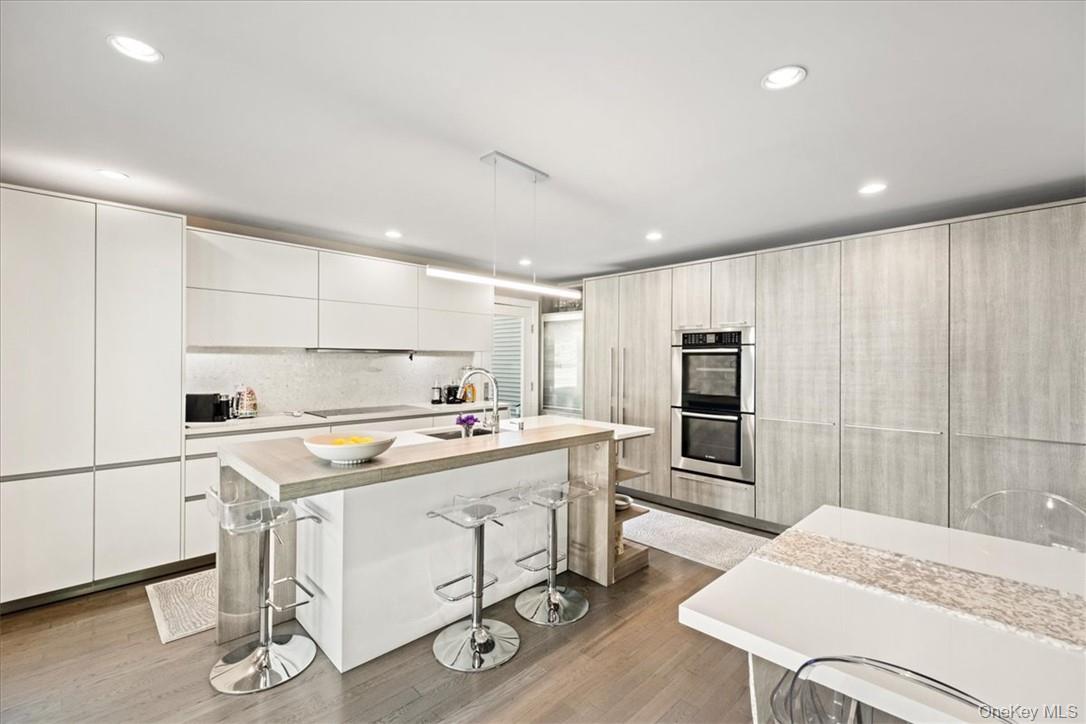 1570 Journeys End Road Croton-on-Hudson, NY 10520 - Photo 17 of 50 a kitchen with a stove a refrigerator and a dining table