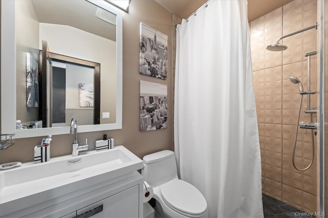 1570 Journeys End Road Croton-on-Hudson, NY 10520 - Photo 28 of 50 a bathroom with a sink a toilet and shower