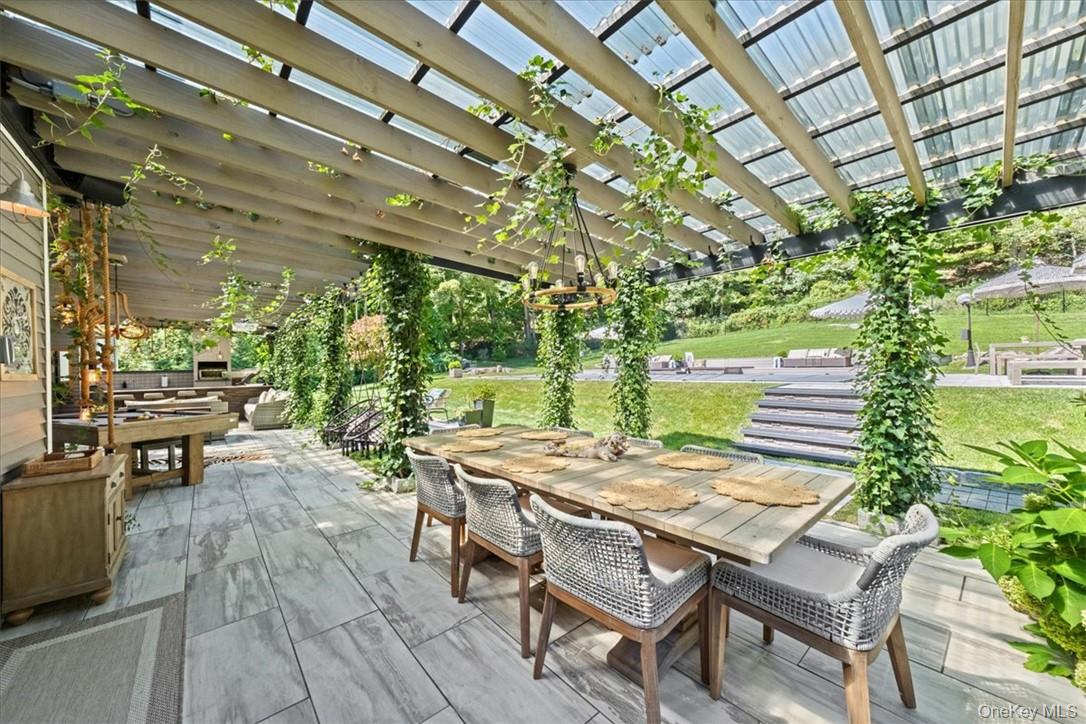 1570 Journeys End Road Croton-on-Hudson, NY 10520 - Photo 31 of 50 a view of a patio with table and chairs and potted plants