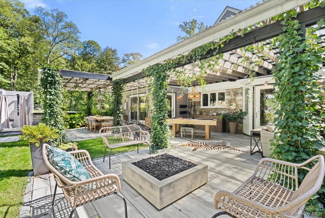 1570 Journeys End Road Croton-on-Hudson, NY 10520 - Photo 32 of 50 a view of a patio with couches table and chairs and potted plants