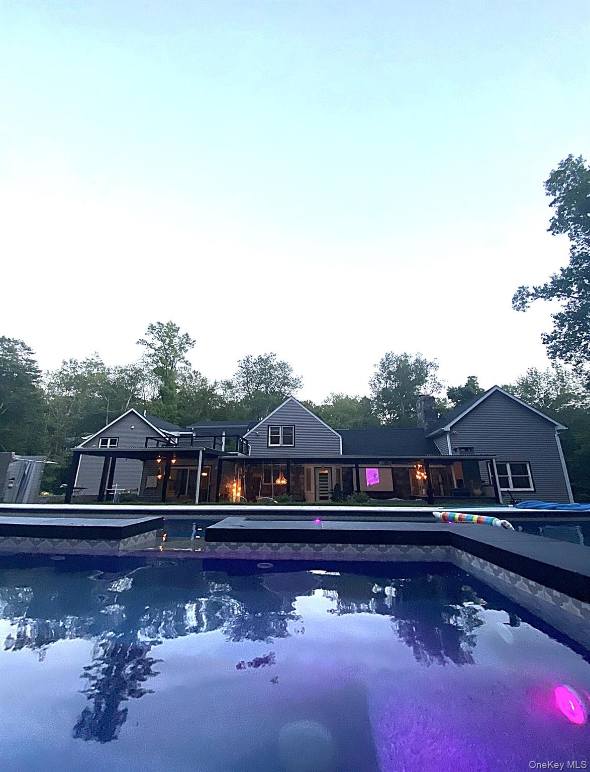 1570 Journeys End Road Croton-on-Hudson, NY 10520 - Photo 45 of 50 a view of a house with swimming pool next to a lake